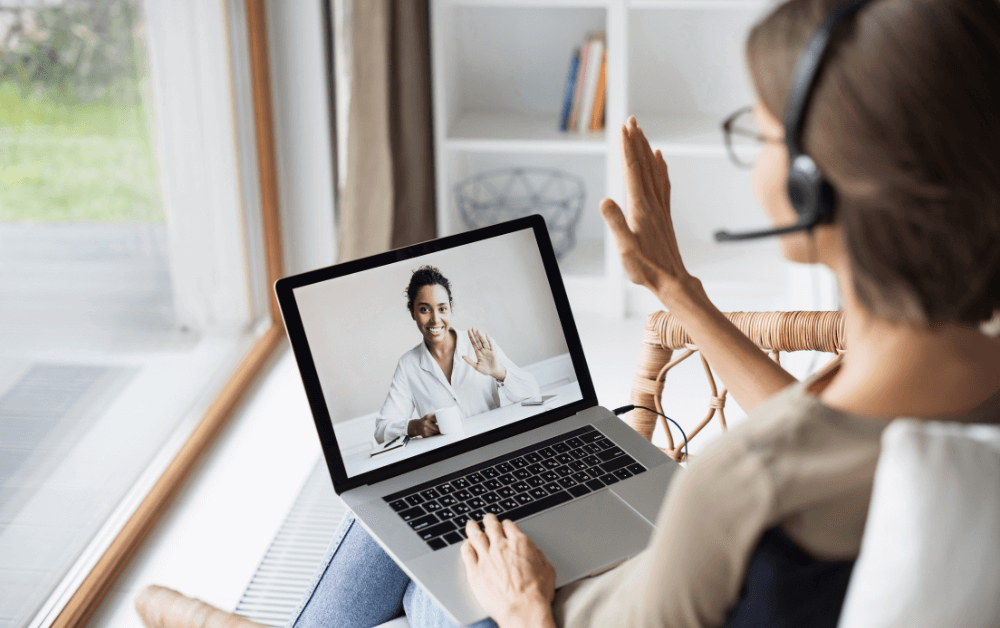 Woman having an online video call coaching session on her laptop