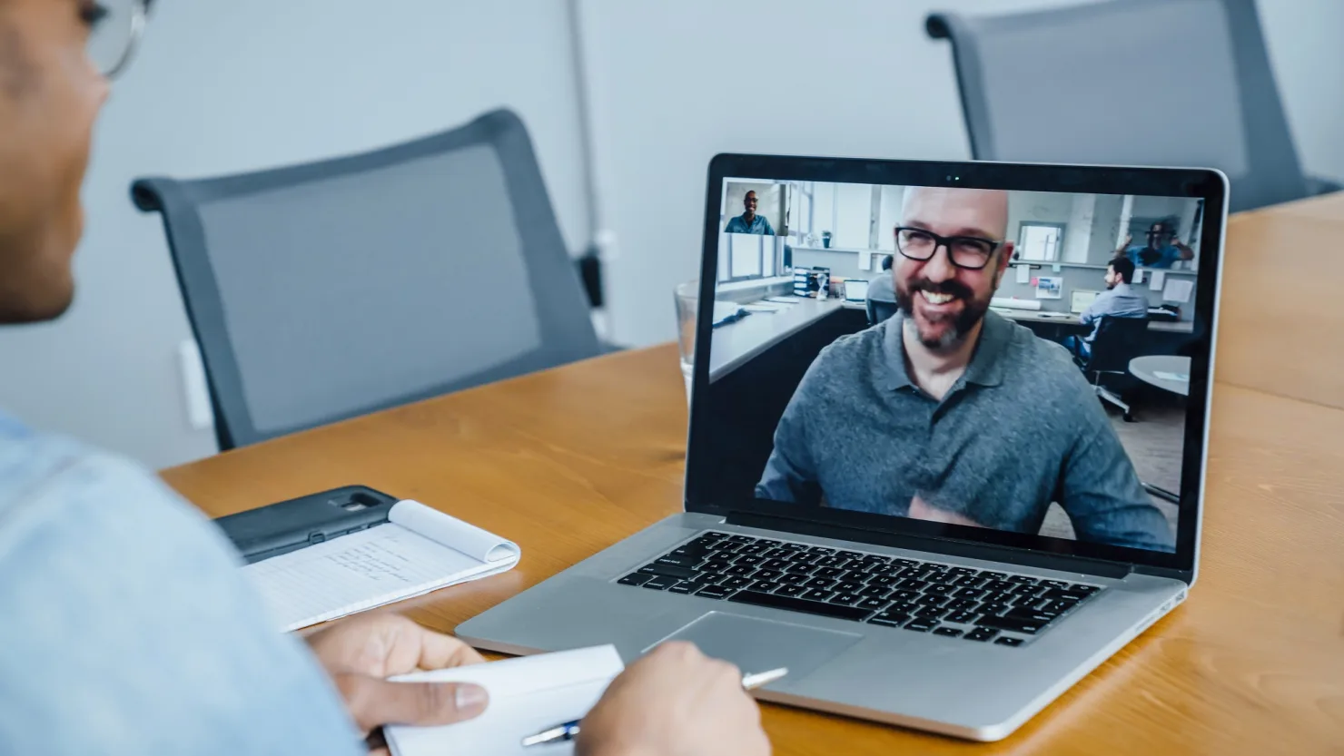 Man engaged in an online video call coaching session on laptop